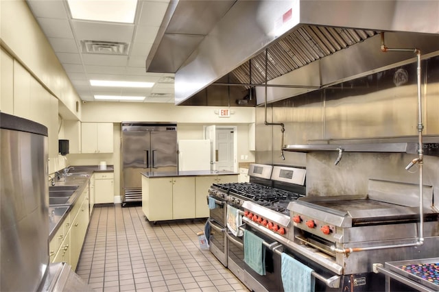 6065 Magpie Dr, Lakeland, FL 33809 - kitchen featuring stainless steel countertops, high quality appliances, a drop ceiling, tile patterned floors, and a sink