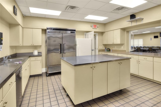 6065 Magpie Dr, Lakeland, FL 33809 - kitchen with stainless steel built in fridge, a sink, dishwasher, a paneled ceiling, and tile patterned floors