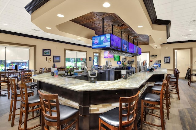 6065 Magpie Dr, Lakeland, FL 33809 - indoor wet bar with recessed lighting, ornamental molding, wood finished floors, and a tray ceiling