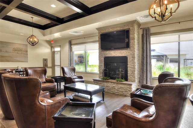 6065 Magpie Dr, Lakeland, FL 33809 - living room with a chandelier, wood finished floors, beamed ceiling, coffered ceiling, and a stone fireplace