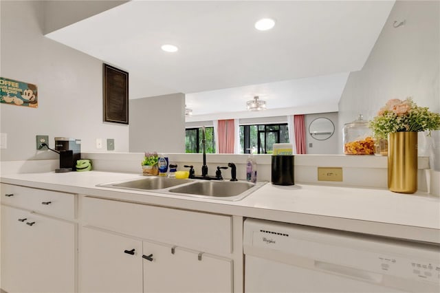321 Birch Way Unit 321, Haines City, FL 33844 - kitchen featuring white dishwasher, a sink, light countertops, white cabinetry, and recessed lighting