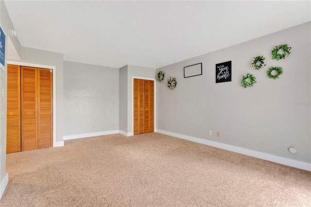 321 Birch Way Unit 321, Haines City, FL 33844 - unfurnished bedroom with carpet floors, baseboards, and two closets