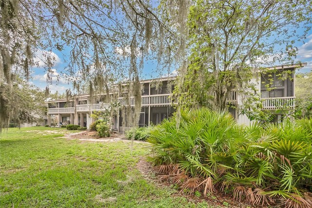 321 Birch Way Unit 321, Haines City, FL 33844 - back of house featuring a sunroom and a yard