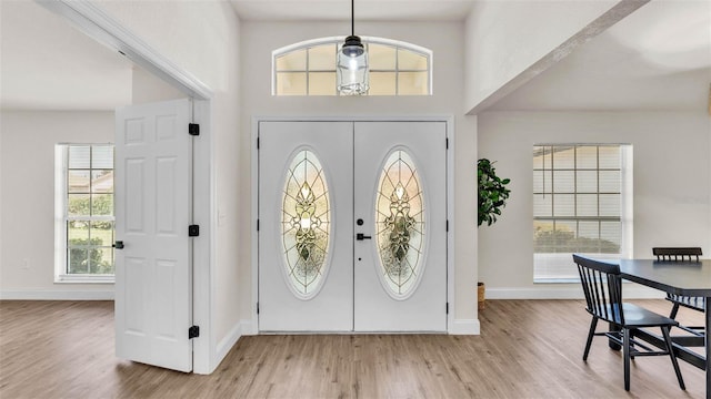 5458 Oakford Dr, Lakeland, FL 33812 - foyer featuring light wood-type flooring, plenty of natural light, and a towering ceiling