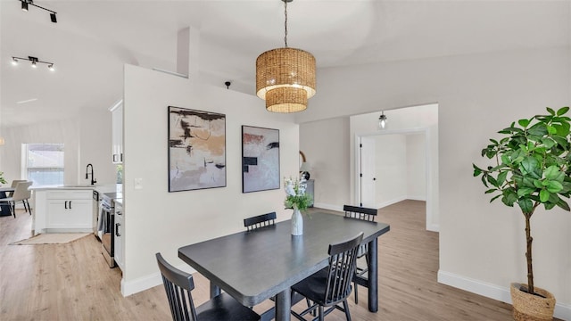5458 Oakford Dr, Lakeland, FL 33812 - dining space featuring light wood-style flooring, baseboards, a chandelier, and lofted ceiling