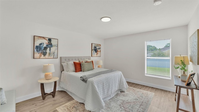 5458 Oakford Dr, Lakeland, FL 33812 - bedroom with light wood finished floors and baseboards
