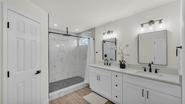 5458 Oakford Dr, Lakeland, FL 33812 - full bath featuring double vanity, a tile shower, and wood finished floors
