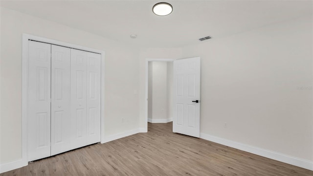 5458 Oakford Dr, Lakeland, FL 33812 - unfurnished bedroom with light wood-style floors, baseboards, and a closet