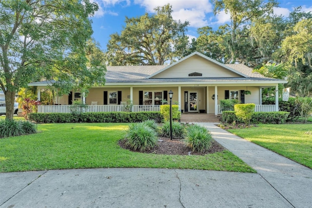 5108 Waterwood Dr, Bartow, FL 33830 - view of front of property featuring covered porch, a front lawn, and a shingled roof