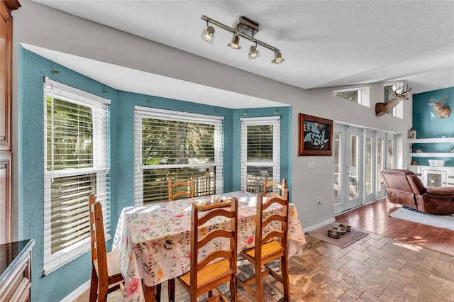 5108 Waterwood Dr, Bartow, FL 33830 - dining room featuring a textured ceiling, plenty of natural light, french doors, and baseboards