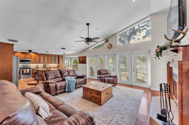 5108 Waterwood Dr, Bartow, FL 33830 - living room with french doors, a ceiling fan, light wood-style floors, recessed lighting, and a textured ceiling