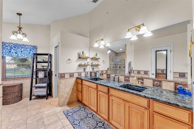 5108 Waterwood Dr, Bartow, FL 33830 - full bath featuring tile patterned floors, tile walls, double vanity, tiled shower, and a chandelier