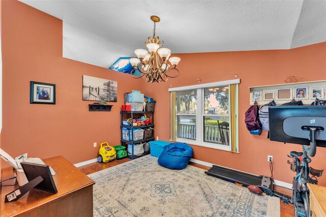 5108 Waterwood Dr, Bartow, FL 33830 - workout area featuring a chandelier, baseboards, wood finished floors, and a textured ceiling