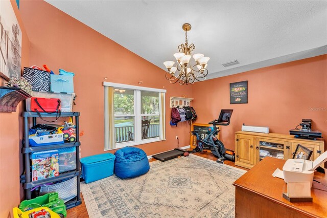 5108 Waterwood Dr, Bartow, FL 33830 - workout area featuring a chandelier, wood finished floors, and lofted ceiling