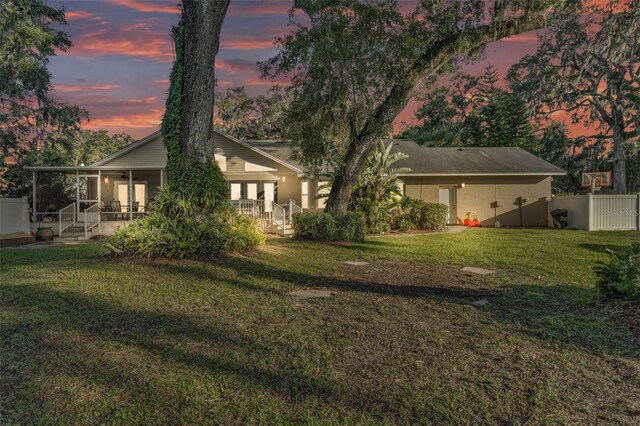 5108 Waterwood Dr, Bartow, FL 33830 - back of house at dusk featuring a sunroom