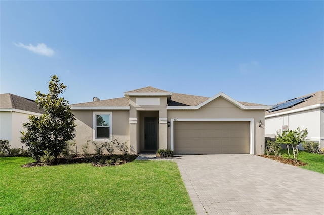 606 Fairview Ave Unit 244, Haines City, FL 33844 - view of front of home featuring stucco siding, an attached garage, decorative driveway, and a front yard