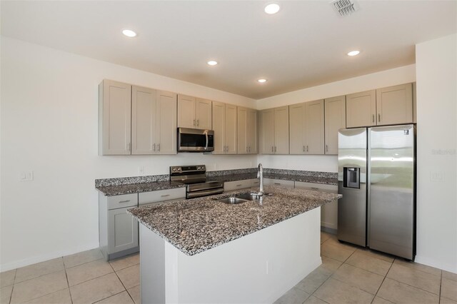 606 Fairview Ave Unit 244, Haines City, FL 33844 - kitchen with stainless steel appliances, a sink, light tile patterned floors, dark stone countertops, and baseboards