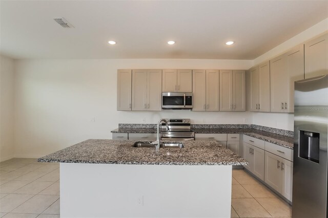 606 Fairview Ave Unit 244, Haines City, FL 33844 - kitchen featuring appliances with stainless steel finishes, a sink, light tile patterned floors, dark stone countertops, and recessed lighting