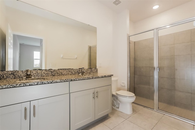 606 Fairview Ave Unit 244, Haines City, FL 33844 - full bathroom featuring double vanity, toilet, a stall shower, and tile patterned floors