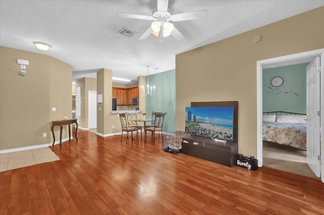 2061 Crestdale Ln Unit 60, Lake Mary, FL 32746 - living area with wood finished floors, ceiling fan, baseboards, and a chandelier