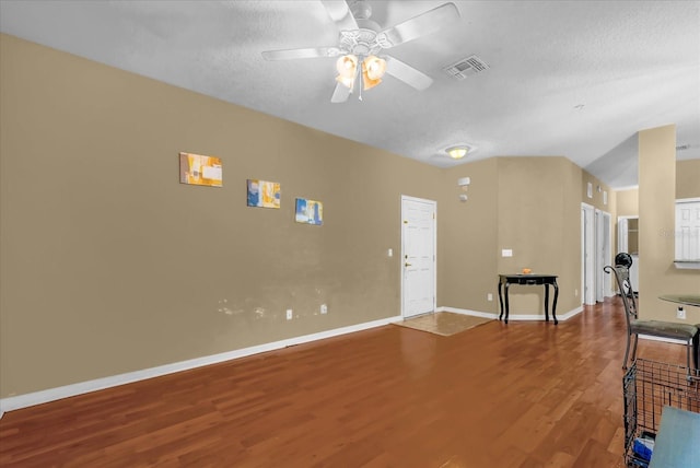 2061 Crestdale Ln Unit 60, Lake Mary, FL 32746 - unfurnished living room with wood finished floors, a ceiling fan, baseboards, a textured ceiling, and vaulted ceiling