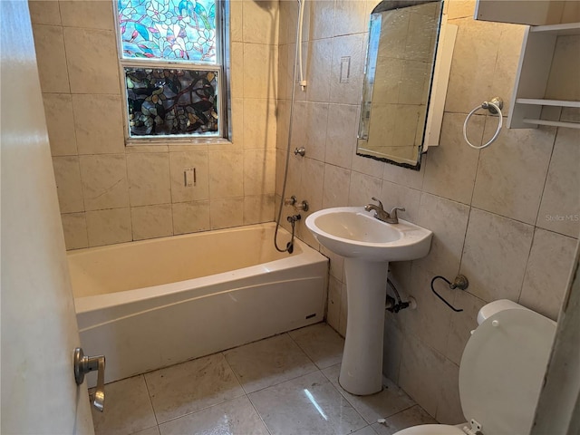 3651 Rifle Range Rd, Winter Haven, FL 33880 - bathroom with toilet, tile walls, tub / shower combination, and tile patterned floors