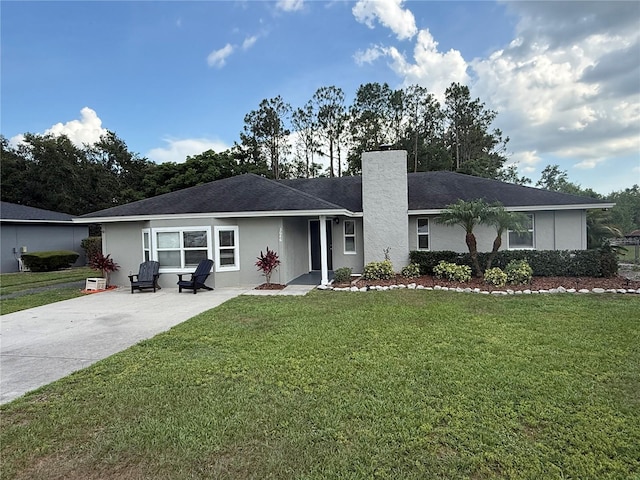 3646 Sherertz Rd, Lakeland, FL 33810 - ranch-style home with a chimney, a front yard, and concrete driveway