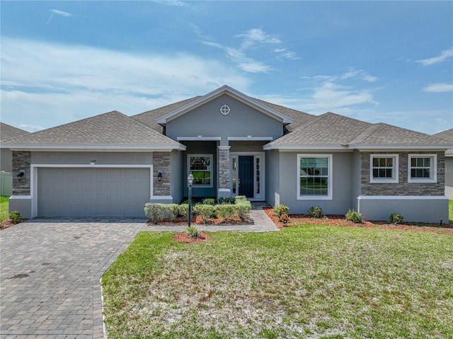 1547 Cordgrass Way, Lakeland, FL 33813 - view of front of home with an attached garage, decorative driveway, a front lawn, stucco siding, and stone siding