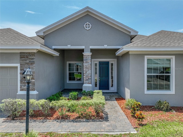 1547 Cordgrass Way, Lakeland, FL 33813 - doorway to property featuring stucco siding, roof with shingles, stone siding, and a garage