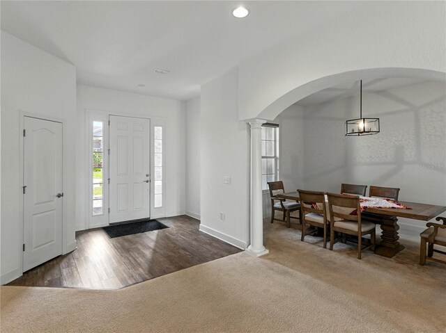 1547 Cordgrass Way, Lakeland, FL 33813 - foyer featuring arched walkways, decorative columns, a chandelier, recessed lighting, and carpet