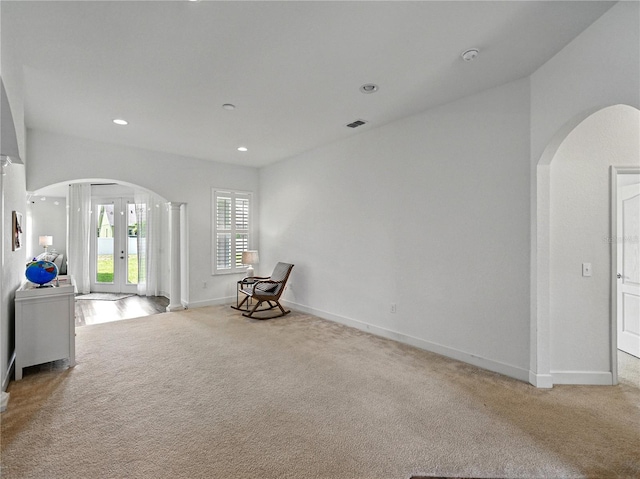 1547 Cordgrass Way, Lakeland, FL 33813 - unfurnished room with arched walkways, carpet, baseboards, and recessed lighting
