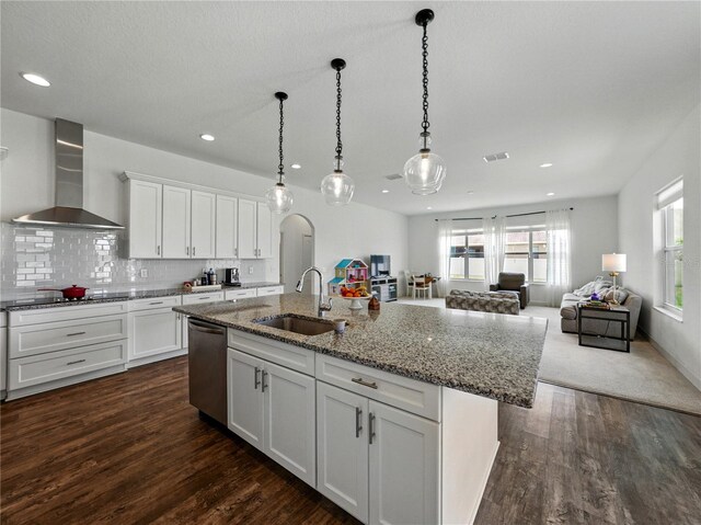1547 Cordgrass Way, Lakeland, FL 33813 - kitchen with wall chimney exhaust hood, stainless steel dishwasher, a sink, white cabinetry, and an island with sink