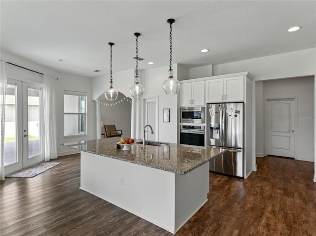 1547 Cordgrass Way, Lakeland, FL 33813 - kitchen featuring appliances with stainless steel finishes, a sink, dark wood-type flooring, recessed lighting, and stone countertops