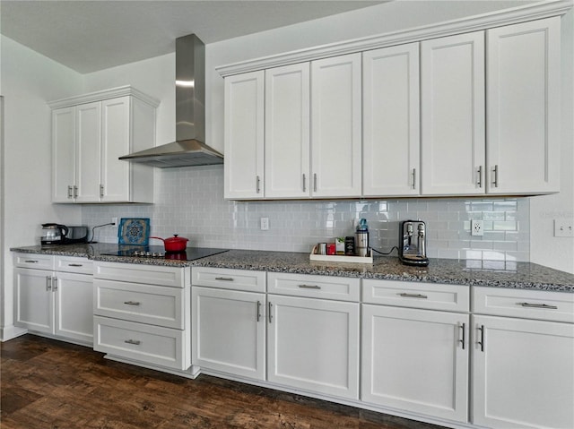 1547 Cordgrass Way, Lakeland, FL 33813 - kitchen with wall chimney exhaust hood, dark stone counters, black electric stovetop, and tasteful backsplash