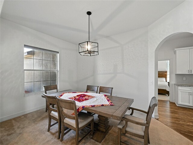 1547 Cordgrass Way, Lakeland, FL 33813 - carpeted dining room with arched walkways, lofted ceiling, and baseboards