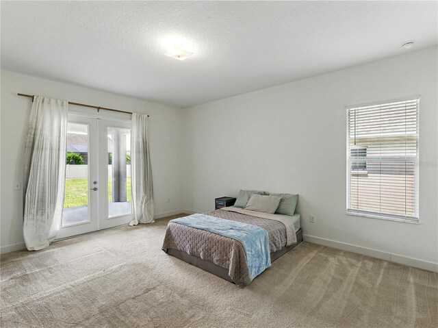 1547 Cordgrass Way, Lakeland, FL 33813 - carpeted bedroom featuring access to outside, french doors, and baseboards