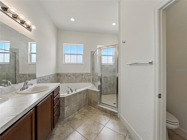 1547 Cordgrass Way, Lakeland, FL 33813 - full bath featuring a bath, vanity, a shower stall, tile patterned floors, and toilet