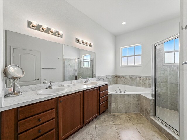 1547 Cordgrass Way, Lakeland, FL 33813 - bathroom featuring a garden tub, double vanity, a shower stall, and tile patterned flooring