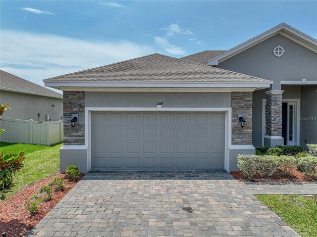 1547 Cordgrass Way, Lakeland, FL 33813 - view of front of property with stone siding, decorative driveway, and an attached garage