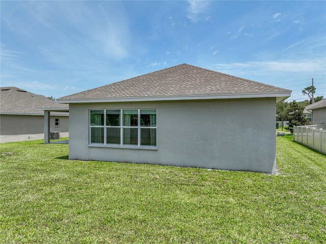 1547 Cordgrass Way, Lakeland, FL 33813 - rear view of house with stucco siding and roof with shingles