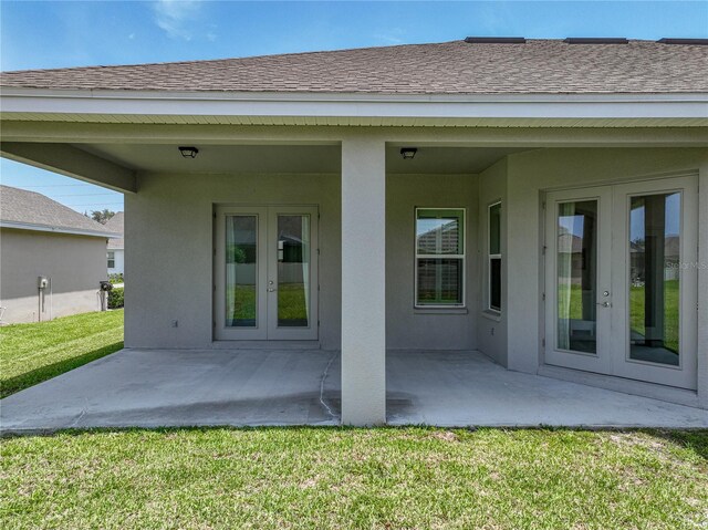 1547 Cordgrass Way, Lakeland, FL 33813 - back of house featuring french doors, a patio area, stucco siding, and a yard