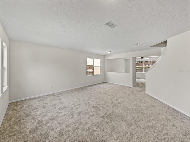 143 Alfani St, Davenport, FL 33896 - carpeted empty room with a textured ceiling, baseboards, and a ceiling fan