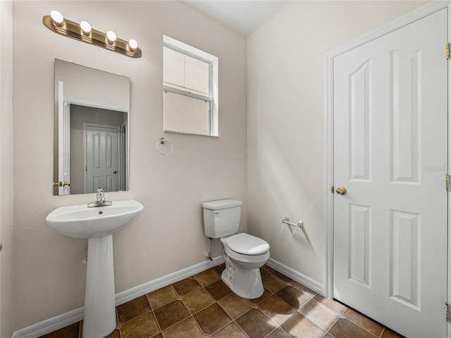 143 Alfani St, Davenport, FL 33896 - bathroom featuring toilet and baseboards
