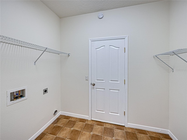 143 Alfani St, Davenport, FL 33896 - laundry room with washer hookup, baseboards, electric dryer hookup, and tile patterned flooring