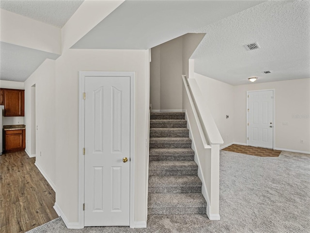 143 Alfani St, Davenport, FL 33896 - staircase with baseboards, a textured ceiling, and carpet flooring