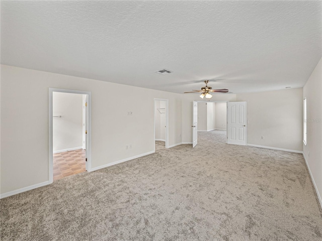 143 Alfani St, Davenport, FL 33896 - unfurnished room featuring light carpet, ceiling fan, baseboards, and a textured ceiling