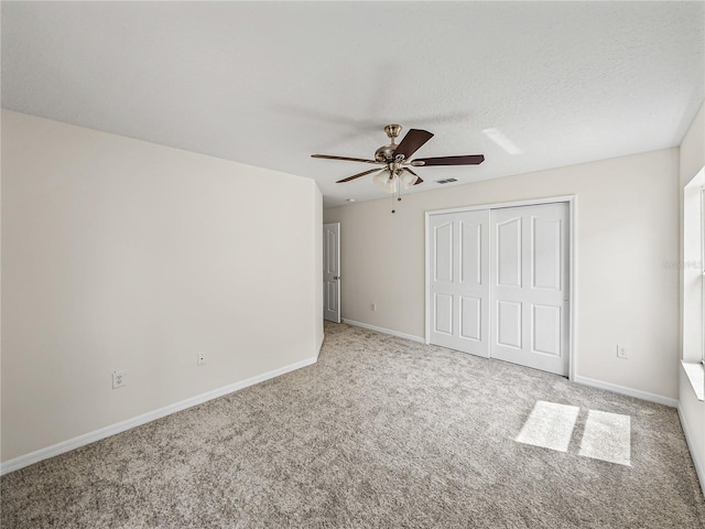 143 Alfani St, Davenport, FL 33896 - unfurnished bedroom with carpet floors, a closet, baseboards, and ceiling fan