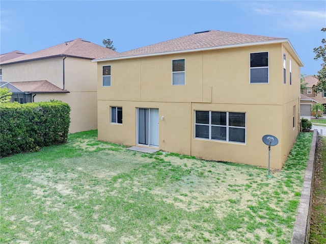 143 Alfani St, Davenport, FL 33896 - back of property with stucco siding, a lawn, and roof with shingles