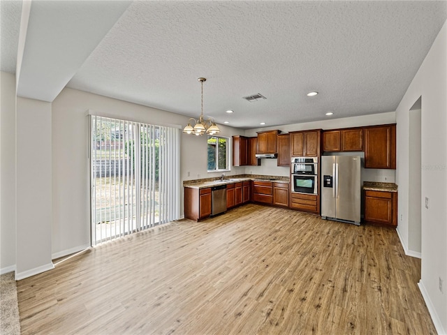 143 Alfani St, Davenport, FL 33896 - kitchen with appliances with stainless steel finishes, a chandelier, light wood-style floors, baseboards, and recessed lighting