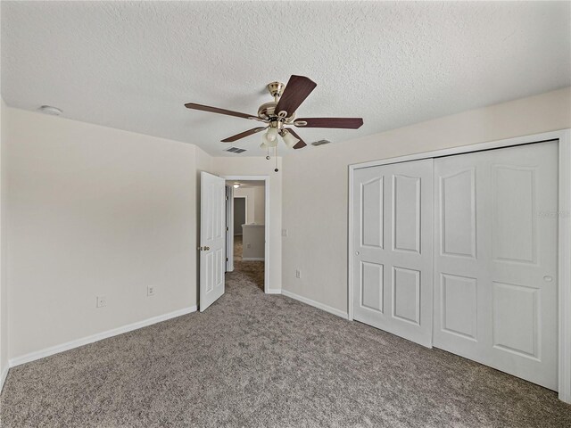 143 Alfani St, Davenport, FL 33896 - unfurnished bedroom with carpet floors, a textured ceiling, baseboards, a closet, and a ceiling fan
